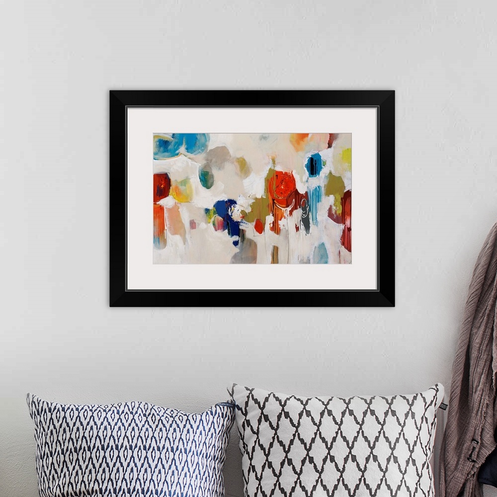 A bohemian room featuring Big, colorful swirls of paint on this horizontal photograph of an abstract painting.