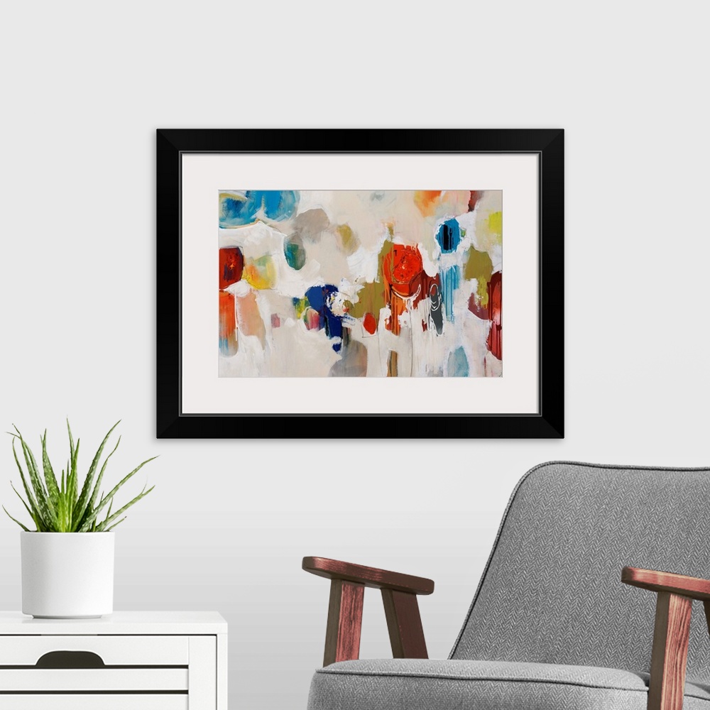 A modern room featuring Big, colorful swirls of paint on this horizontal photograph of an abstract painting.