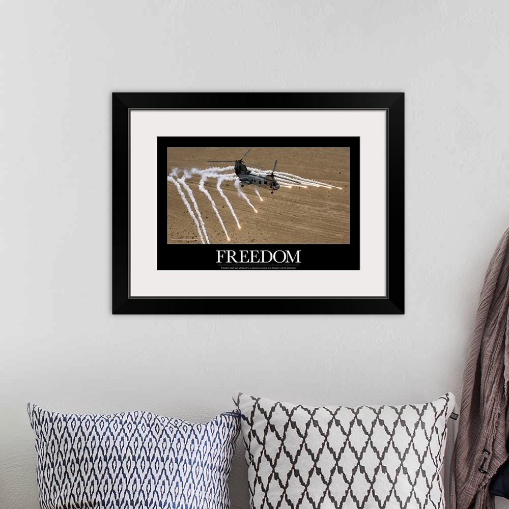A bohemian room featuring A military helicopter is pictured as it shoots numerous flares above the desert. The word freedom...