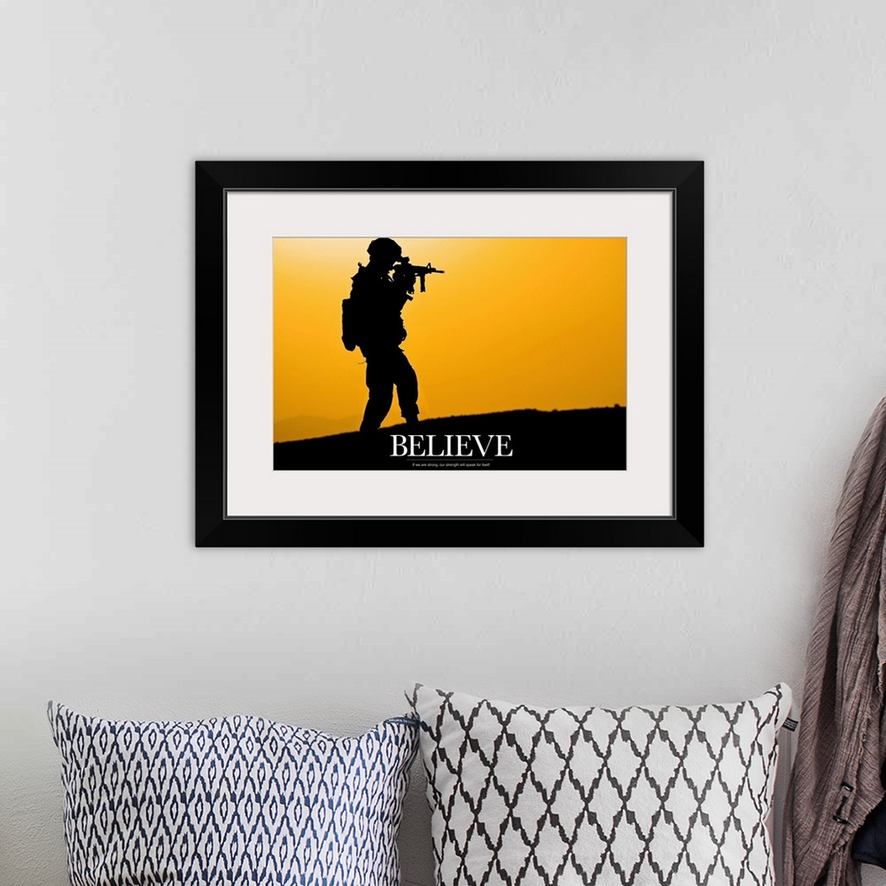 A bohemian room featuring This piece shows a silhouette of a solider holding his gun with the word "Believe" written below ...