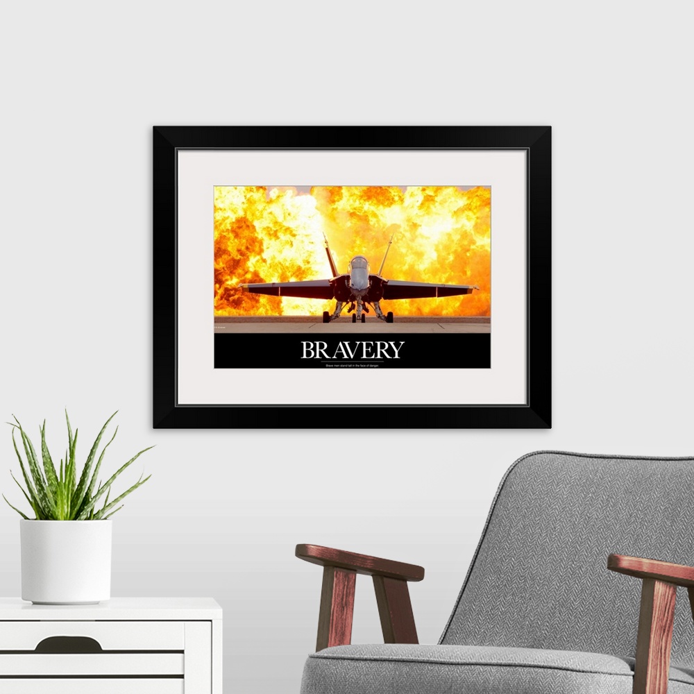 A modern room featuring Military poster of a picture taken straight on of an aircraft that has a fiery explosion behind i...