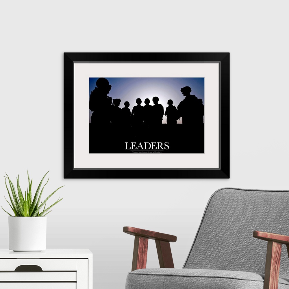 A modern room featuring Large photo of the silhouette of soldiers standing against a clear sky with text at the bottom.
