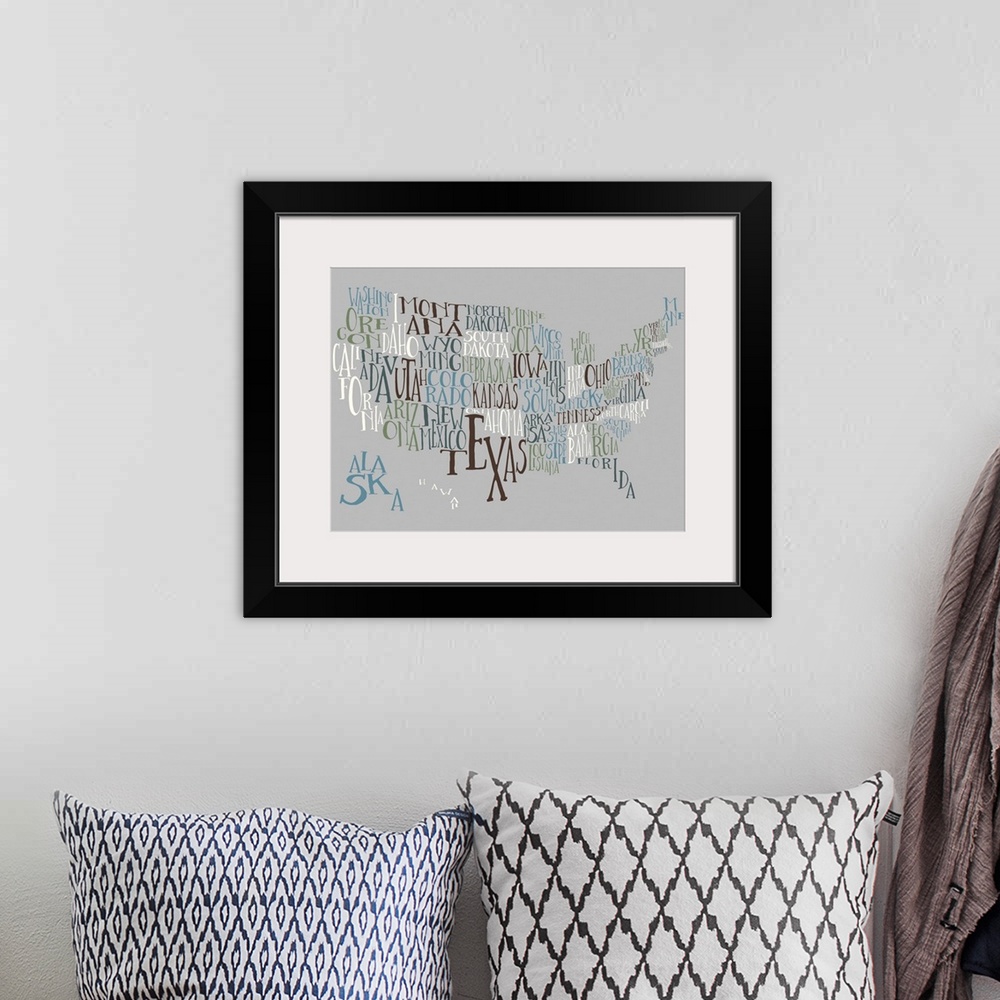 A bohemian room featuring A hand-drawn typography map of the United States with all the state names, in white, blue, and bl...