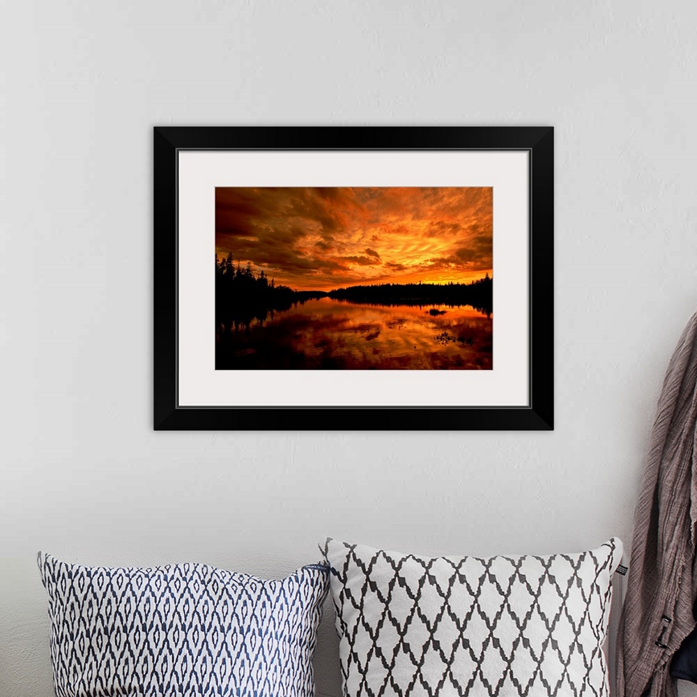 A bohemian room featuring Horizontal photograph from the National Geographic Collection of a golden sunset over a lake, und...