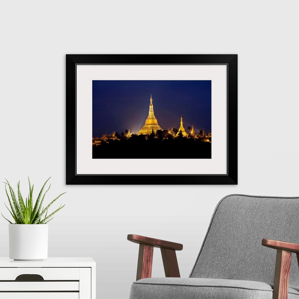 A modern room featuring This landscape photograph shows a religious site illuminated in the night riding above the silhou...