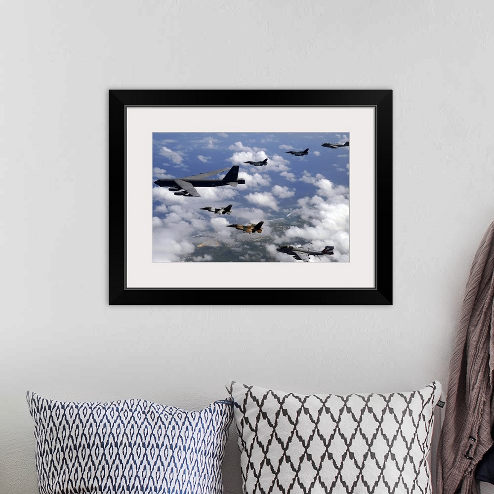 A bohemian room featuring Military aircrafts are photographed flying high and in formation over Guam.
