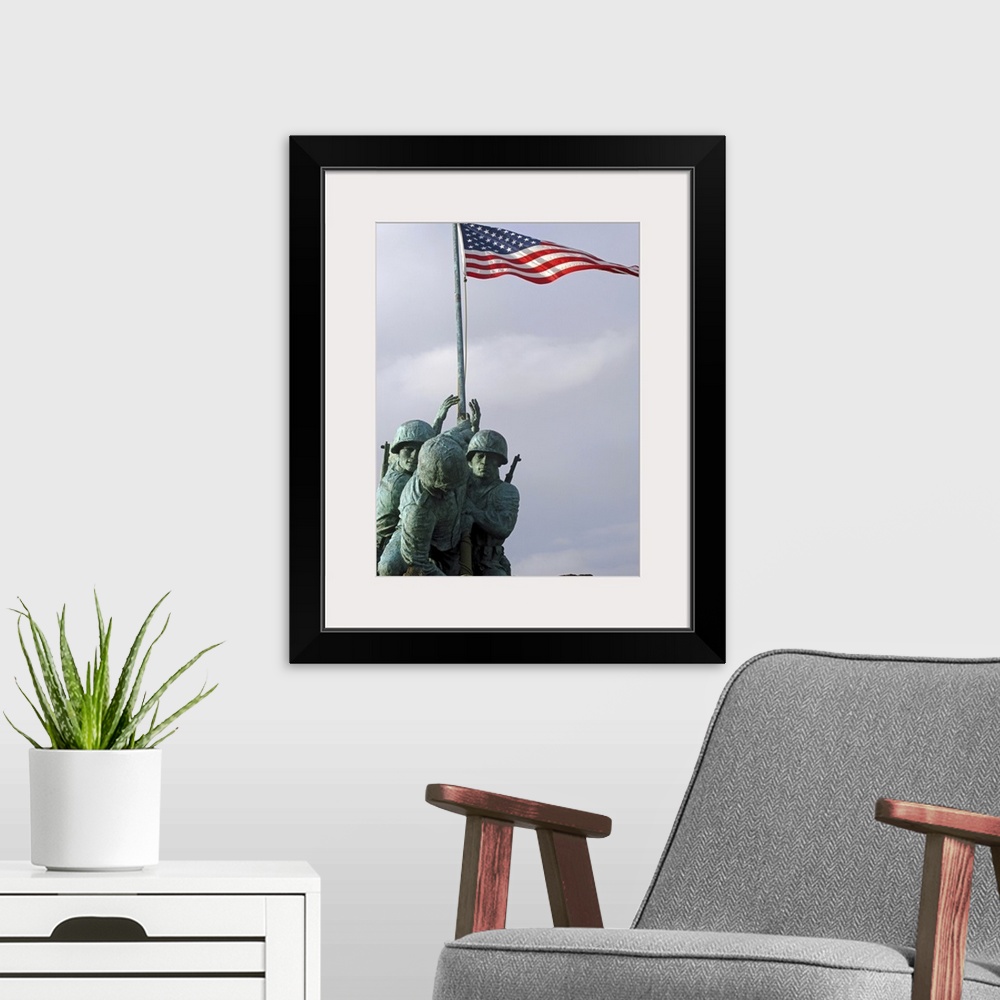 A modern room featuring Up-close photograph of monument of soldiers lifting the American flag.