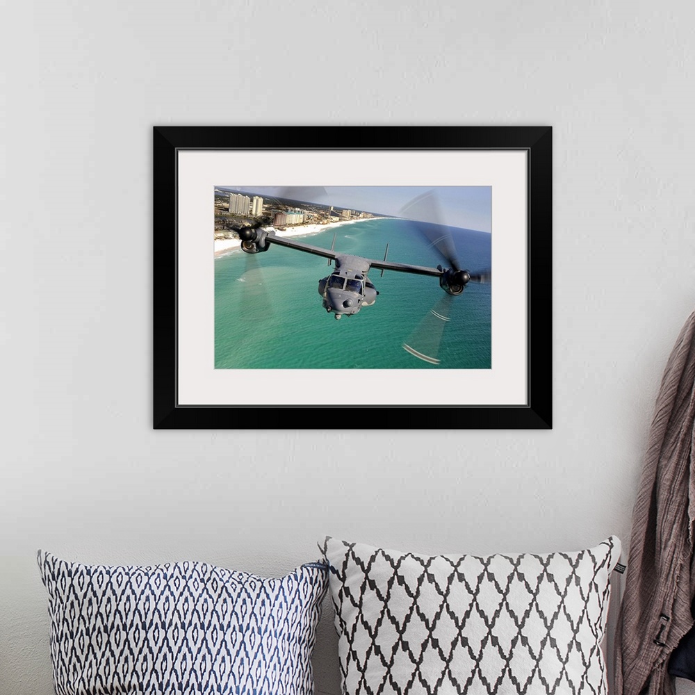 A bohemian room featuring Large landscape photograph of a CV22 Osprey aircraft flying toward the camera, over the green and...