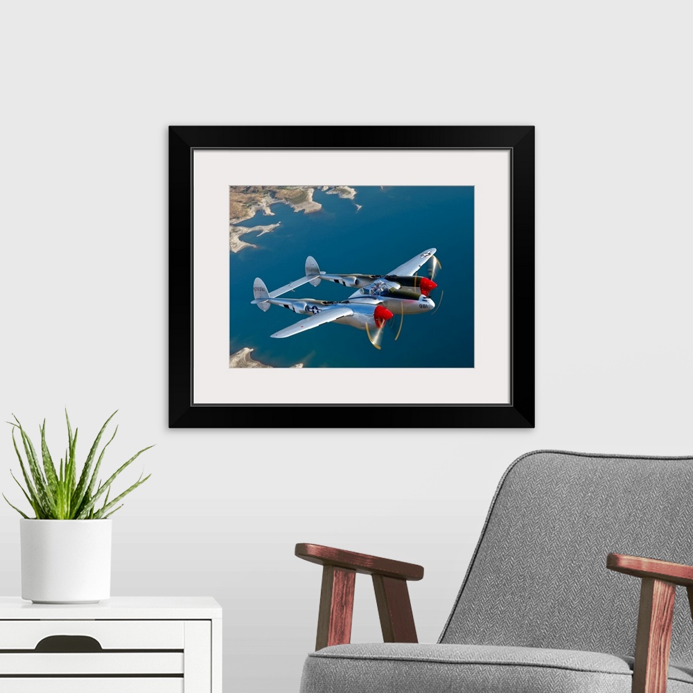 A modern room featuring Canvas photo art of a vintage airplane flying above water.