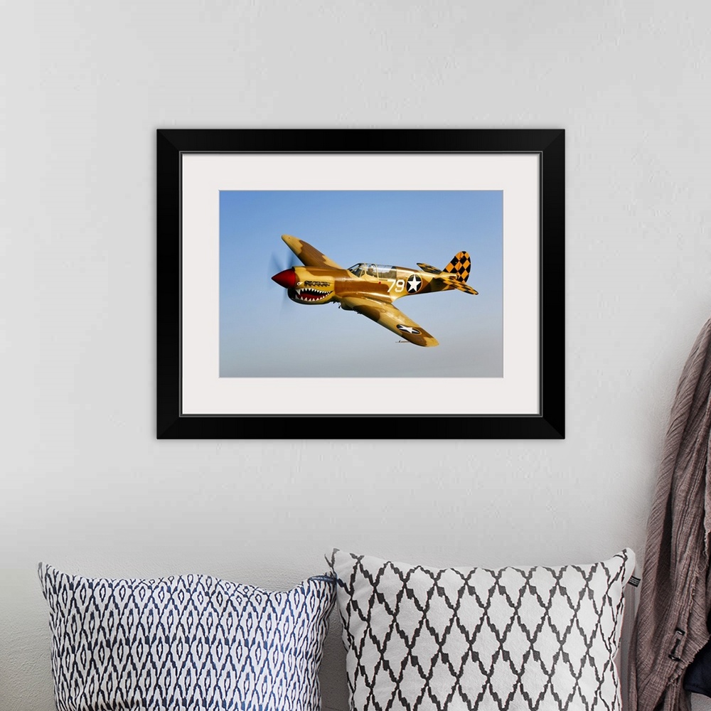 A bohemian room featuring Landscape photograph on a big canvas of a P-40N Warhawk in flight in a clear blue sky, near Chino...
