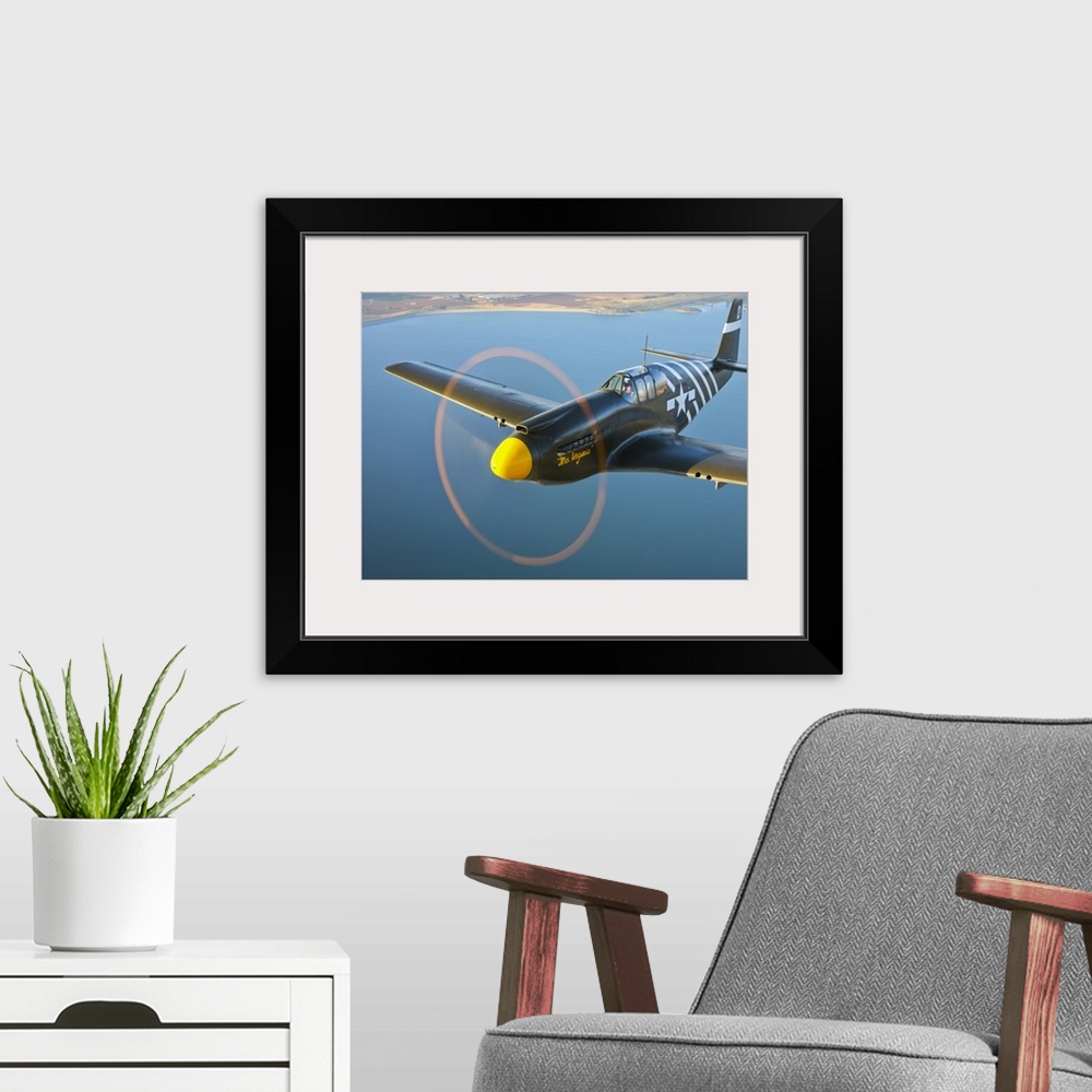 A modern room featuring A P-51A Mustang in flight near Chino, California.