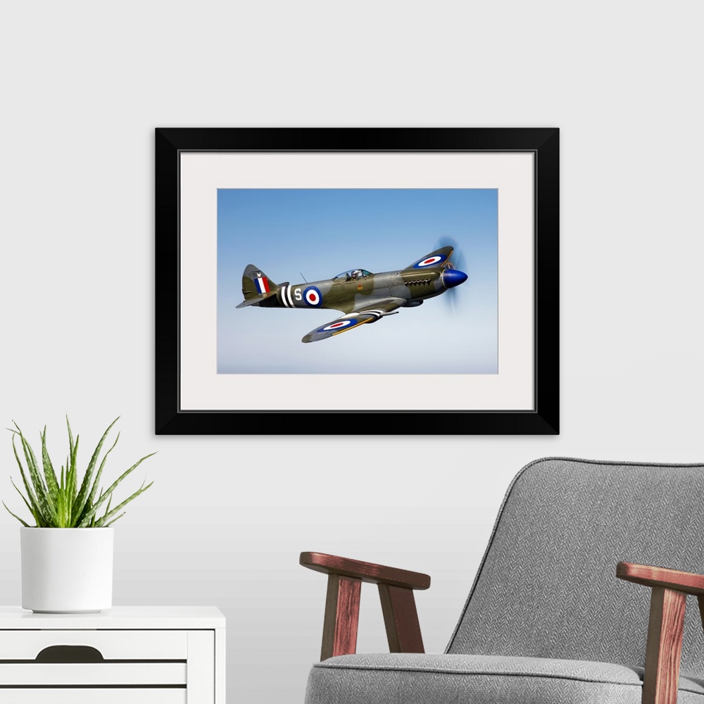 A modern room featuring An image of a vintage styled military jet flying through the sky printed on canvas.