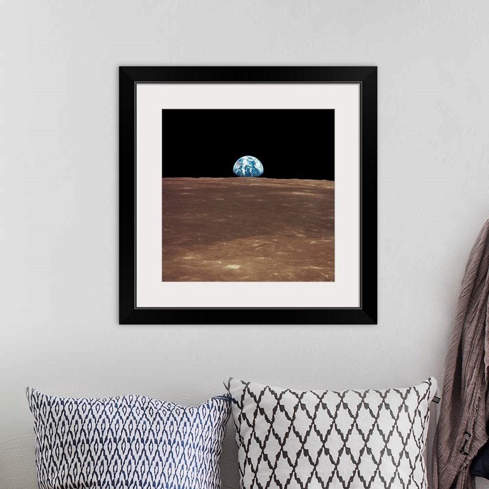 A bohemian room featuring View from the moon's surface of the earth rising over the horizon. It is a sight only a few astro...