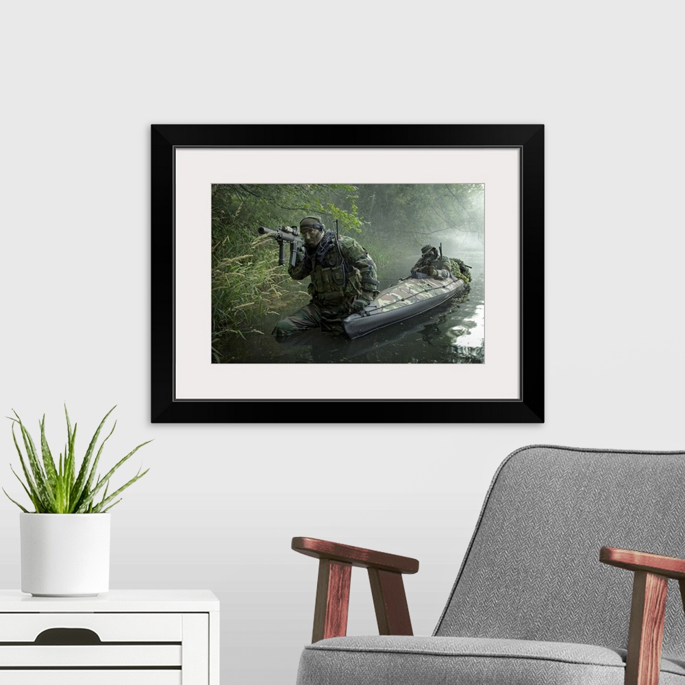 A modern room featuring A dramatic photograph of soldiers as they walk through water armed and ready.