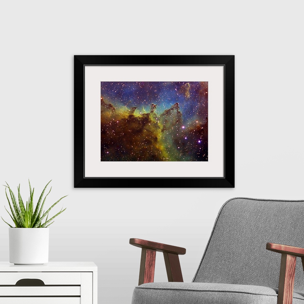 A modern room featuring Photograph of stars with multicolored waves of gas and clouds in the background.
