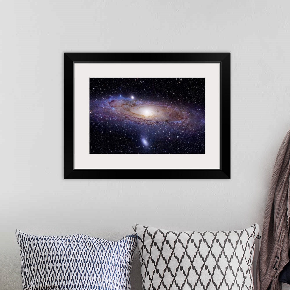 A bohemian room featuring Landscape photograph of a spiral galaxy 2.5 million light years away.