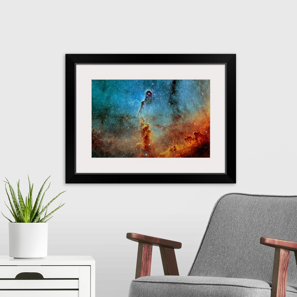 A modern room featuring Large photograph showcases a concentration of interstellar gas and dust within the much larger io...