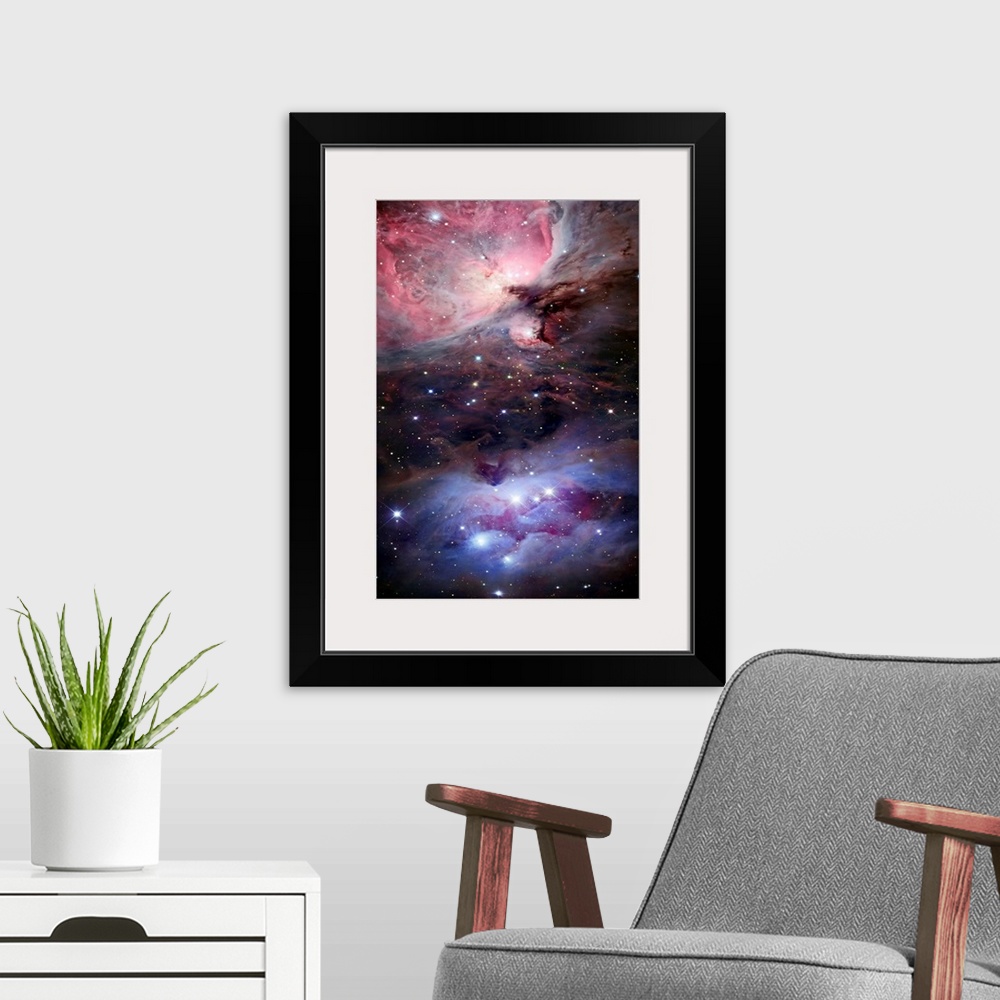 A modern room featuring Large photograph depicts a portion of space littered with brightly filled stars, three of which m...