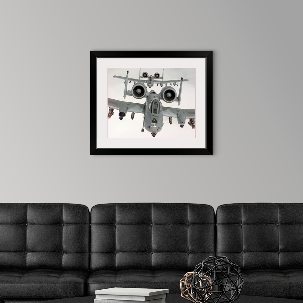 A modern room featuring Two US Air Force A10A Warthogs in flight