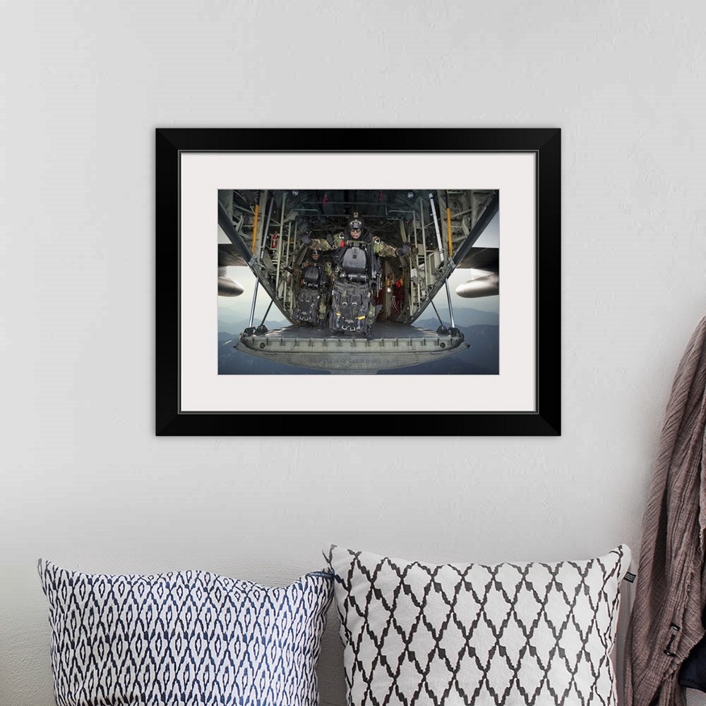 A bohemian room featuring Landscape photograph of a U.S. Navy SEAL combat diver, loaded with gear, preparing to jump from t...