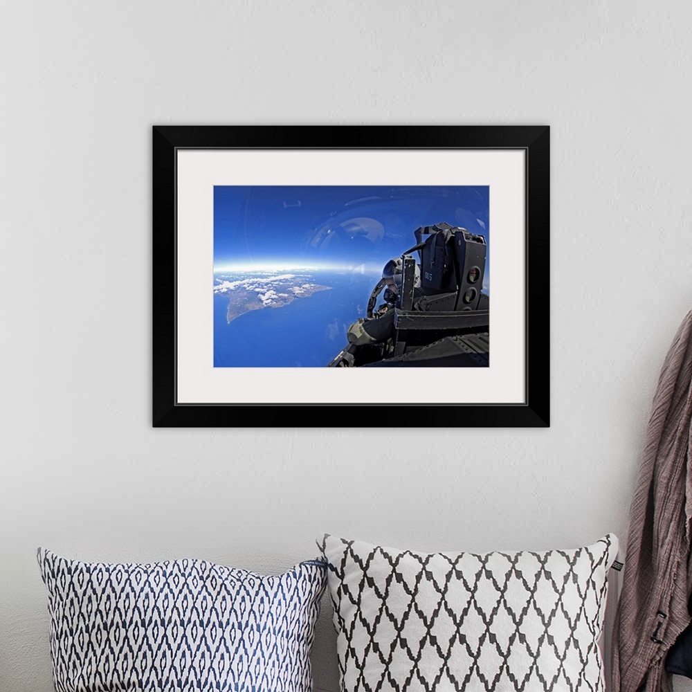 A bohemian room featuring US Air Force captain looks out over the sky in a F15 Eagle