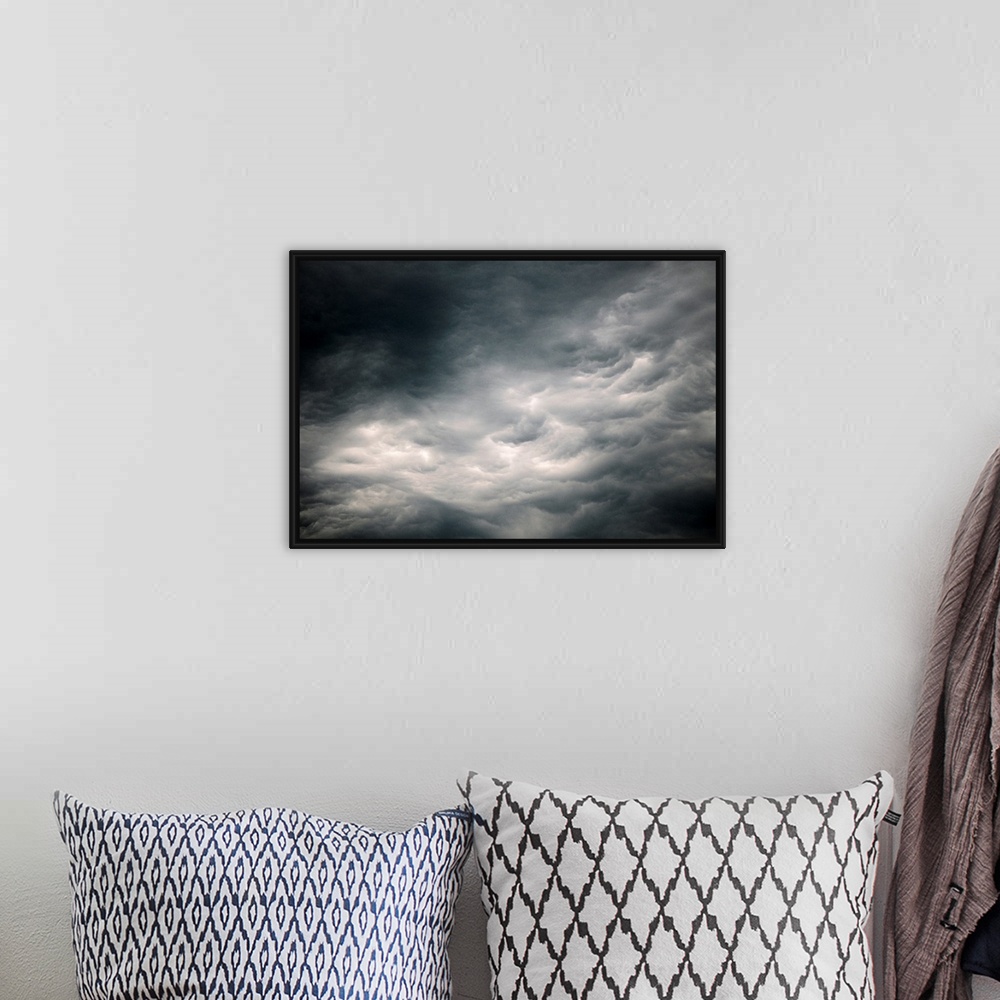 A bohemian room featuring Photograph of dark, ominous rain clouds in the sky.