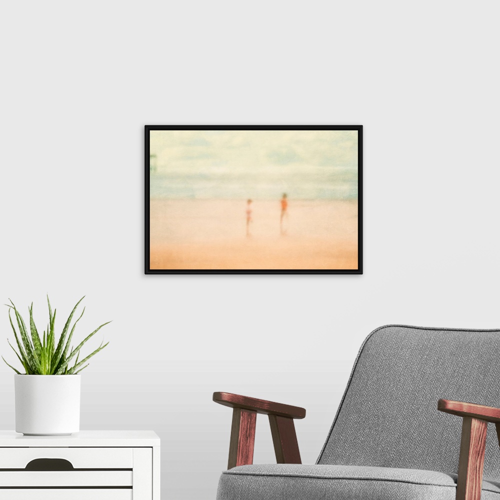 A modern room featuring Soft focus painting of two children standing on the beach with ocean and pier in distance.