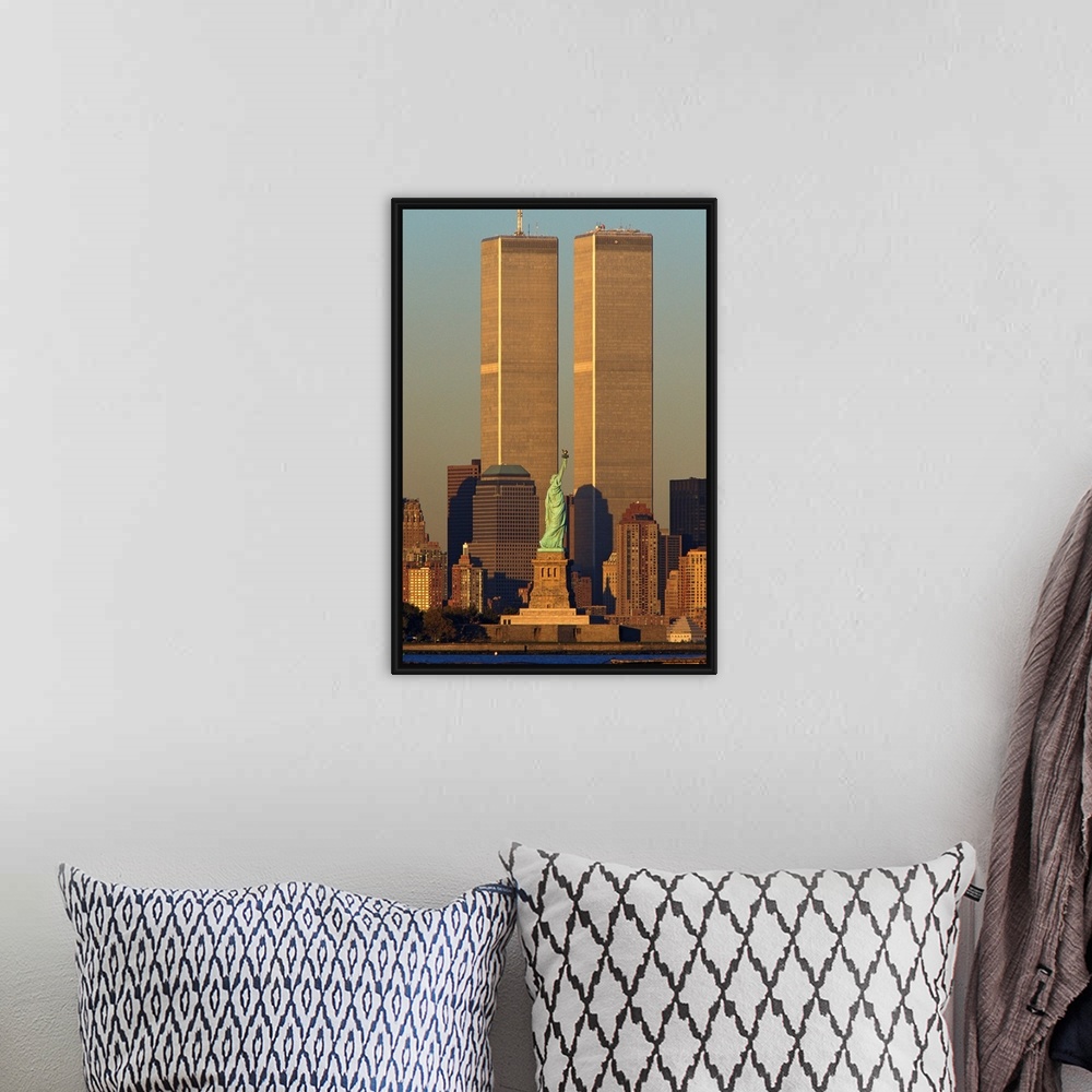 A bohemian room featuring Vertical photograph of the World Trade Center towering over Manhattan with the Statue of Liberty ...