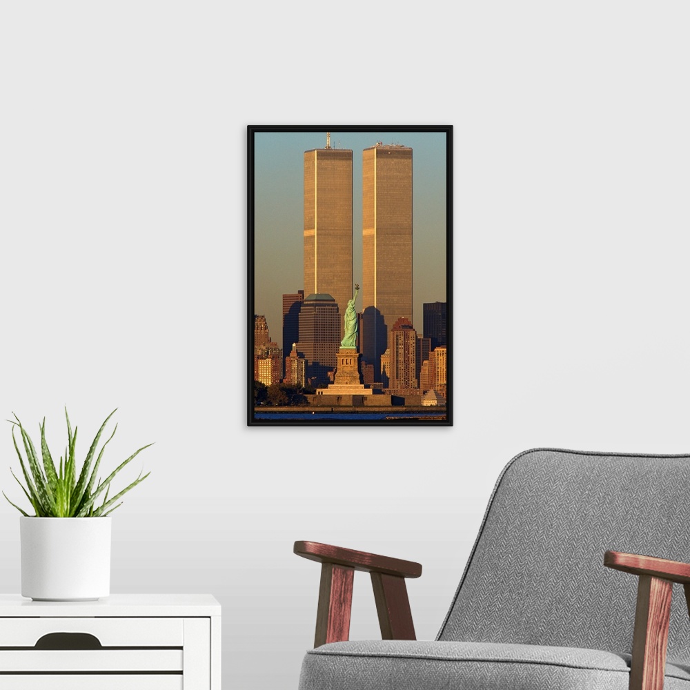A modern room featuring Vertical photograph of the World Trade Center towering over Manhattan with the Statue of Liberty ...