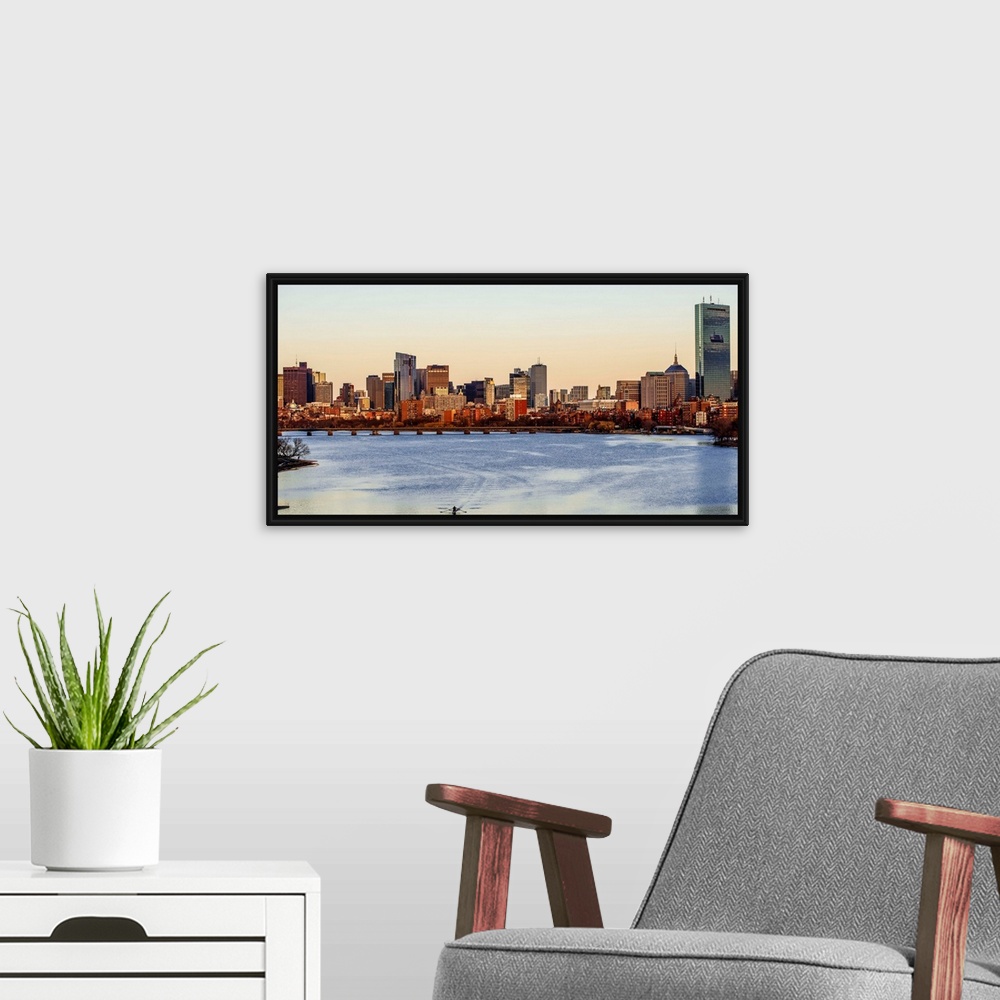 A modern room featuring Panoramic view of the Boston City skyline at sunset, seen from across the water.