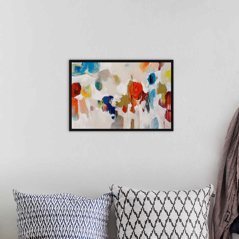 A bohemian room featuring Big, colorful swirls of paint on this horizontal photograph of an abstract painting.