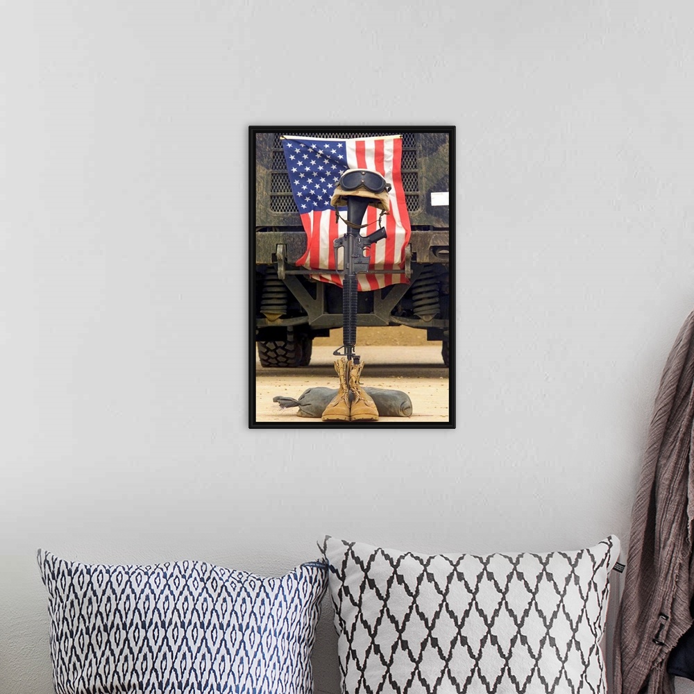 A bohemian room featuring Tall photo on canvas of a rifle sticking out of two boots with a helmet on top in front of an Ame...