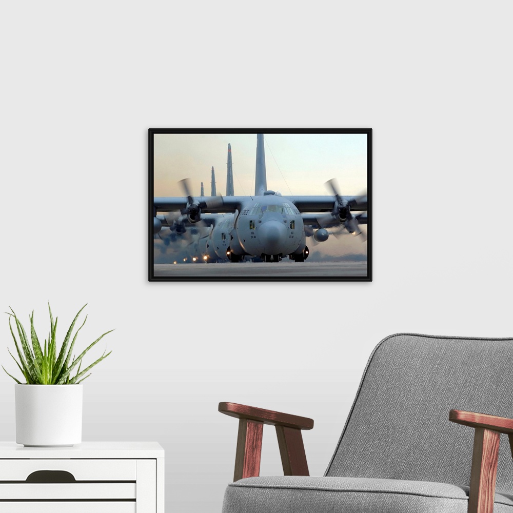 A modern room featuring Several of these tried and true military aircrafts line up on a runway with their massive propell...