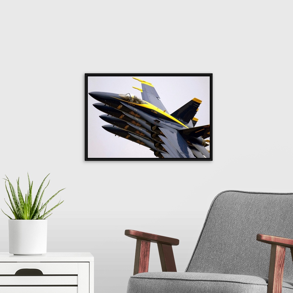 A modern room featuring Four jets are photographed while turned to their side so that they appear to be one on top of the...
