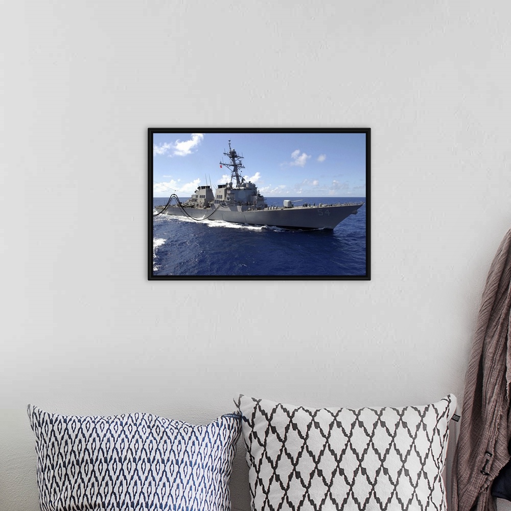 A bohemian room featuring Big canvas photo art of a navy ship in the ocean.