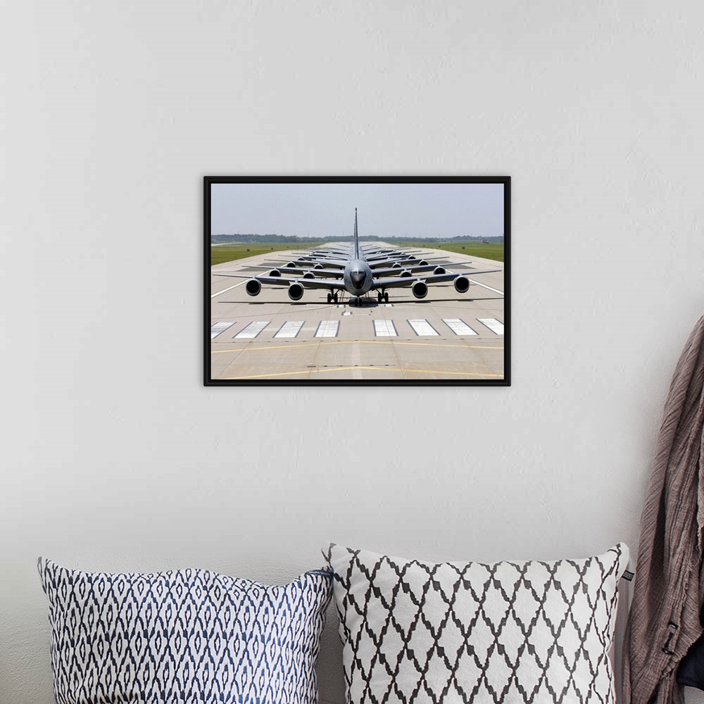 A bohemian room featuring Photograph of several large Stratotanker airplanes perfectly lined up in a row on a runway.