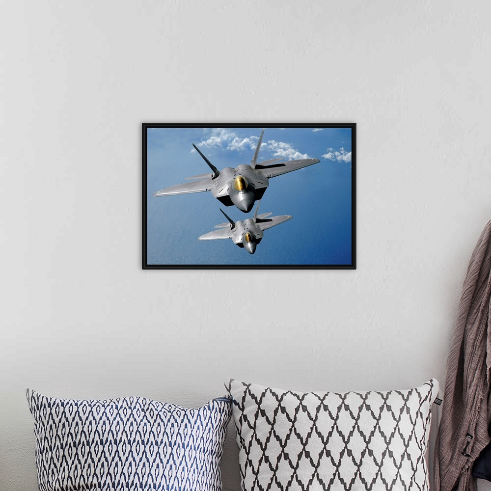 A bohemian room featuring Large, landscape photograph of two F22 Raptors flying high in the sky above the blue waters of th...