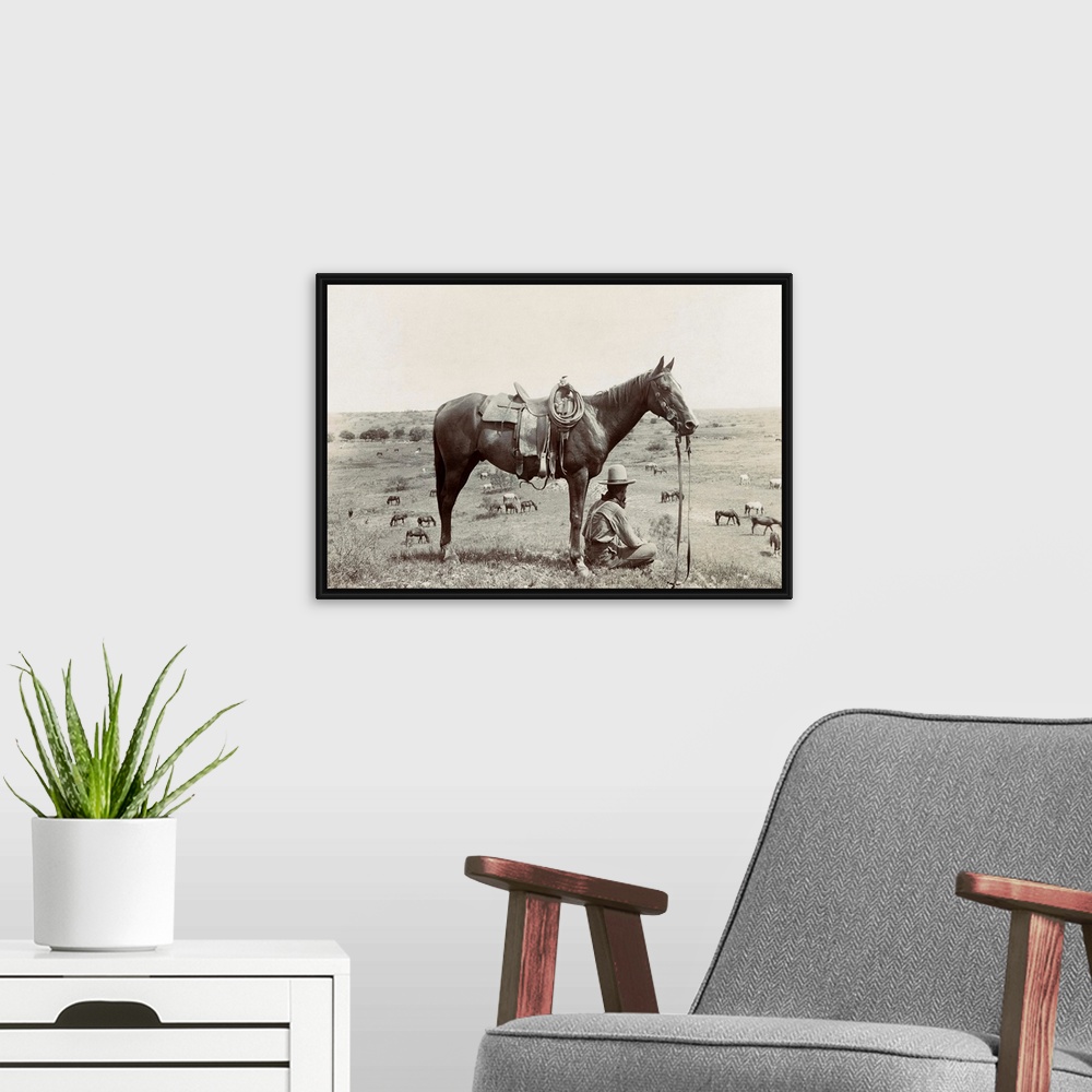 A modern room featuring Texas, Cowboy, C1910. A Horse Wrangler Seated Next To His Horse On A Hill And Looking Down At Oth...