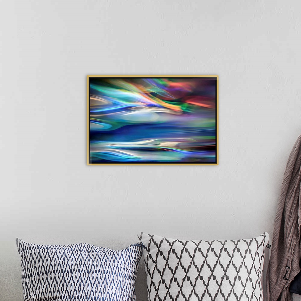 A bohemian room featuring Wall art that has moving multicolored lines that are composed in an abstract fashion.