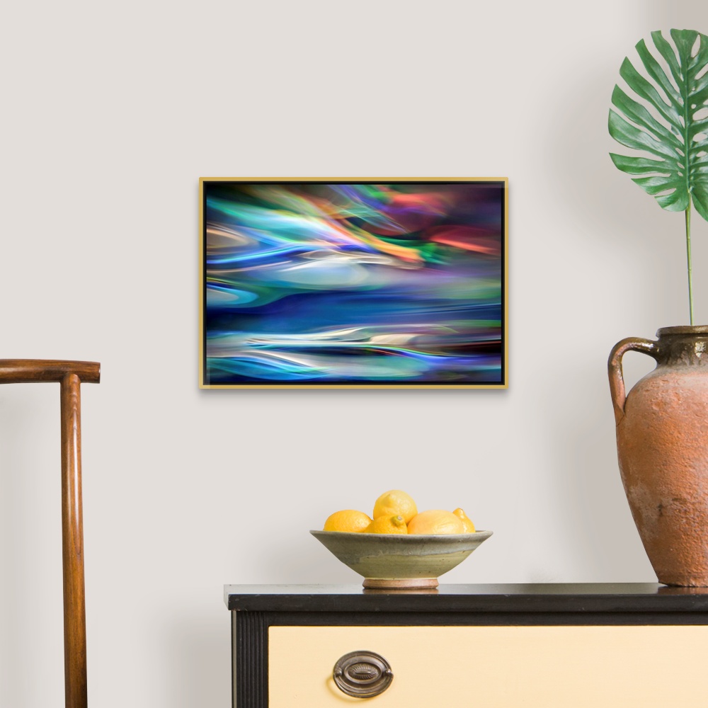 A traditional room featuring Wall art that has moving multicolored lines that are composed in an abstract fashion.