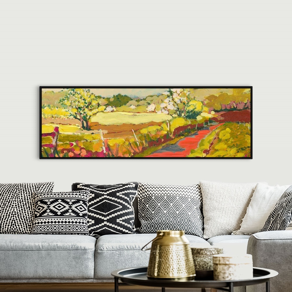 A bohemian room featuring A panoramic piece of artwork that displays a road in the countryside.  The fence and large tree i...