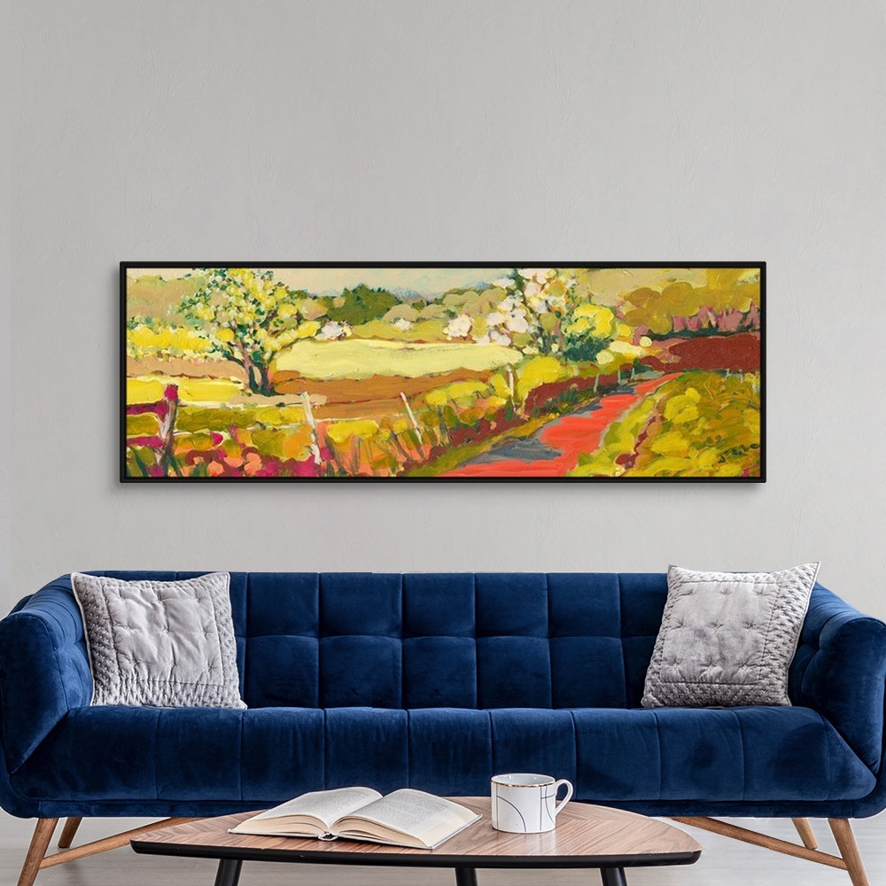 A modern room featuring A panoramic piece of artwork that displays a road in the countryside.  The fence and large tree i...