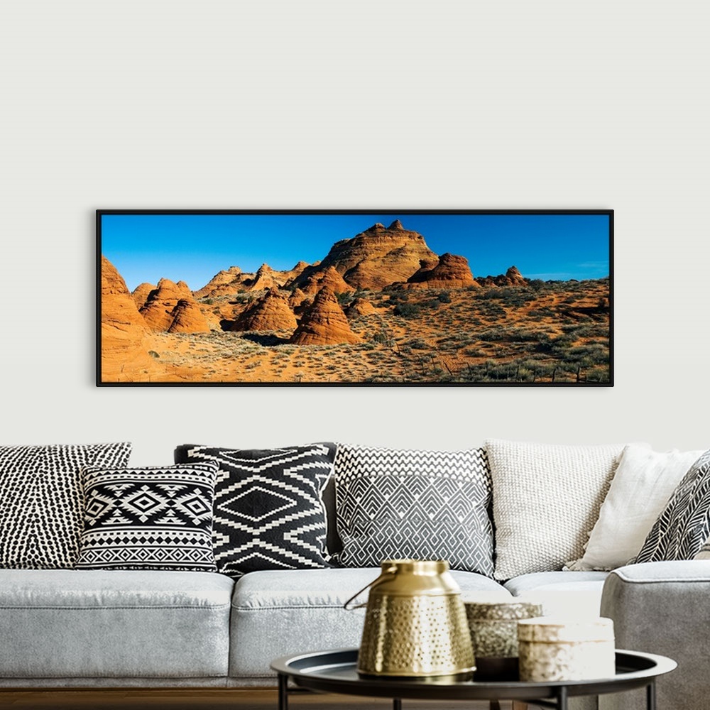 A bohemian room featuring Panoramic photograph shows a field of rock structures among a dry terrain in the Southwestern Uni...