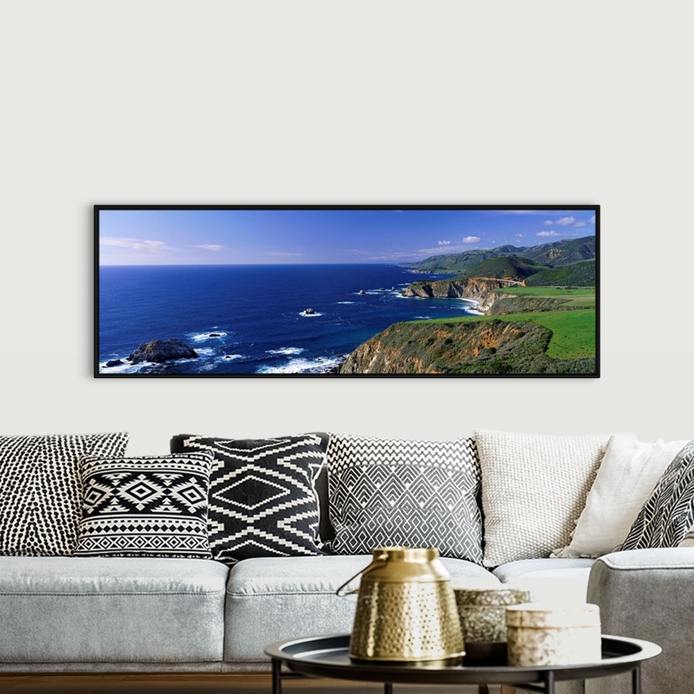 A bohemian room featuring This wall art is a panoramic photograph of the coastal cliffs and the open ocean beyond.