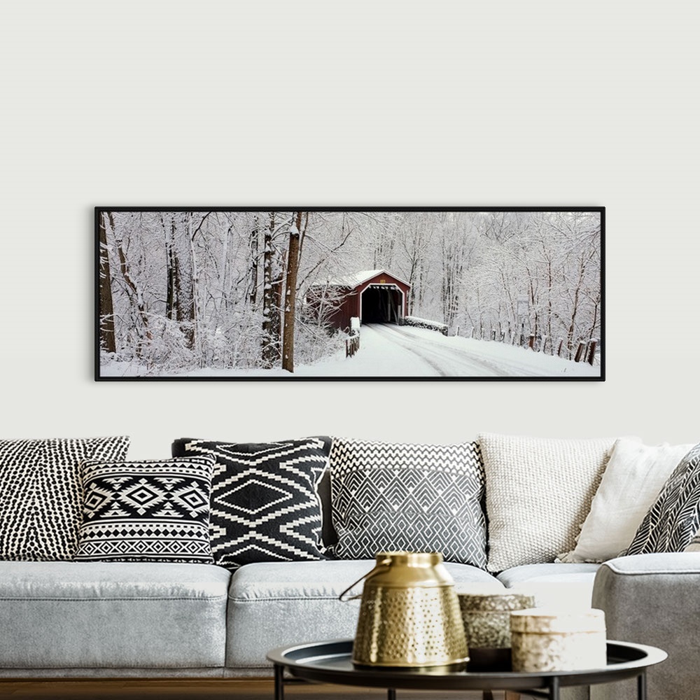 A bohemian room featuring Panoramic photograph of a snow covered bridge in Pennsylvania that is surrounded by a forest.