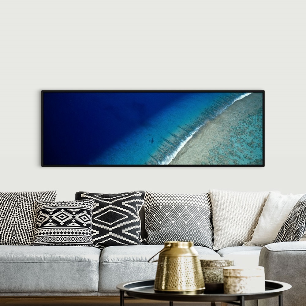A bohemian room featuring Large panoramic wall hanging photograph depicting an aerial view of a sand beach on Teti'aroa Isl...