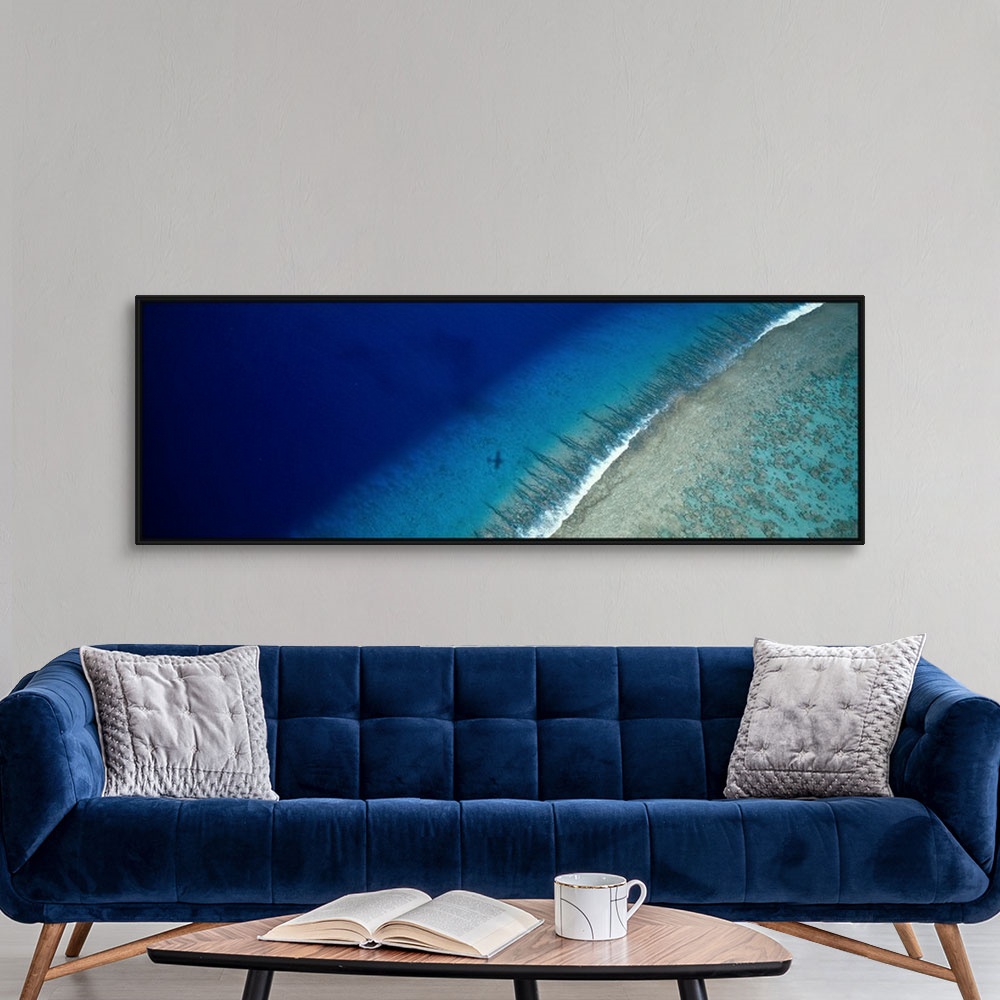 A modern room featuring Large panoramic wall hanging photograph depicting an aerial view of a sand beach on Teti'aroa Isl...