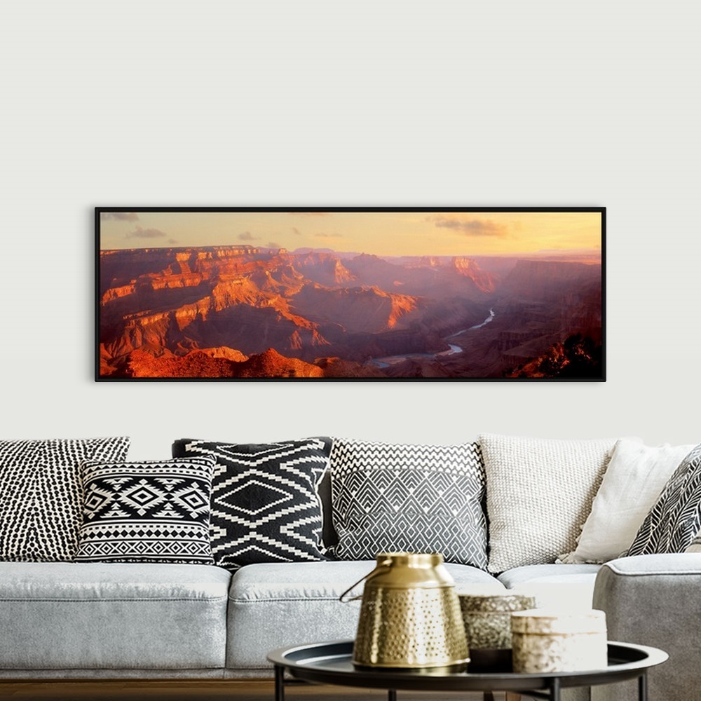 A bohemian room featuring Panoramic photograph of gorge with a stream running through the base.  There is fog with only a f...
