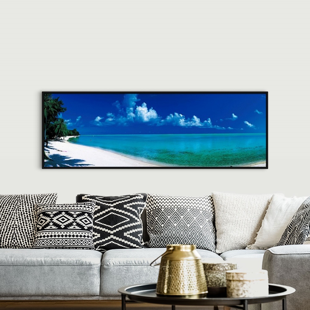 A bohemian room featuring Oversized wall hanging of a sunlit shoreline in Bora Bora, Polynesia with calm waters leading int...