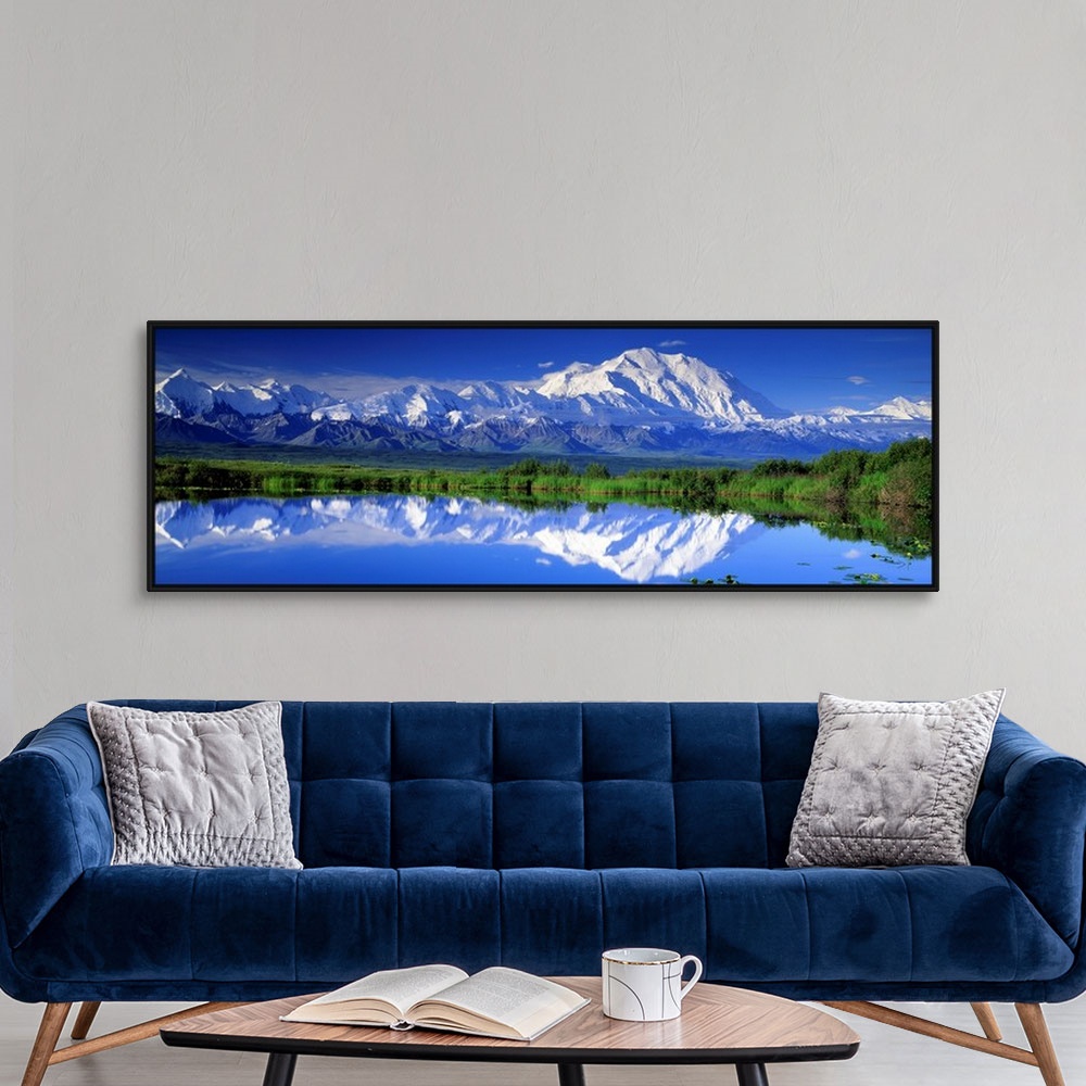 A modern room featuring Panoramic view of snowcapped mountains and Mt. McKinley reflecting in still waters.